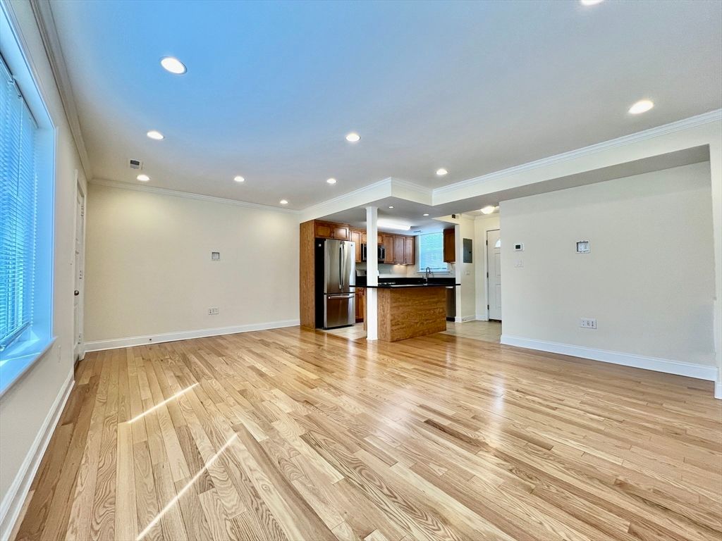 Empty room, Interior, Kitchen, Recessed Lighting, Stainless Steel Appliances, Wood Texture Flooring