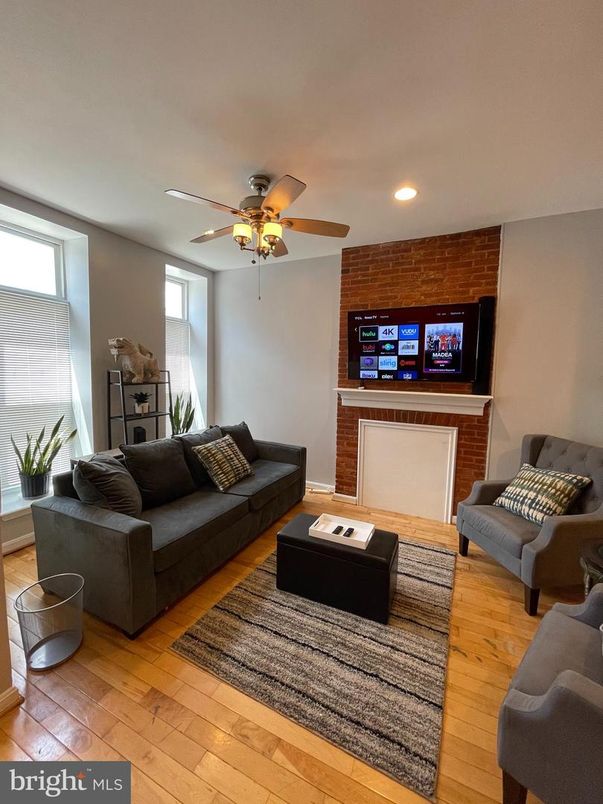Fireplace, Interior, Living room, Recessed Lighting, Stone Walls, Wood Texture Flooring