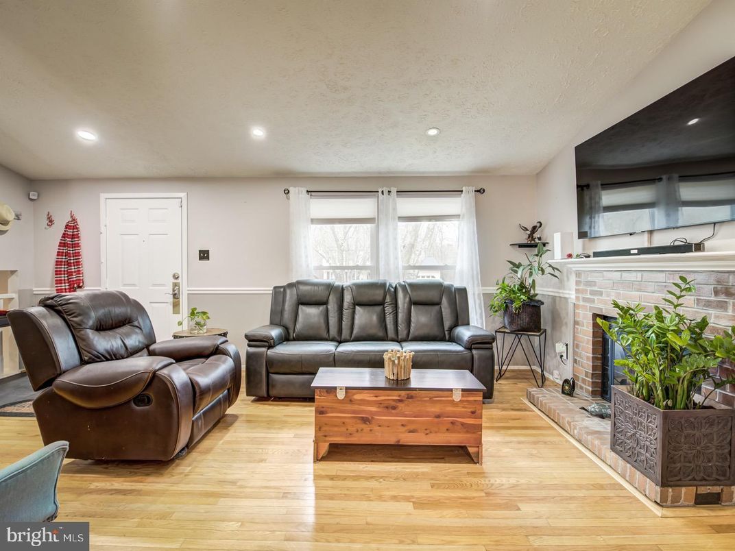 Fireplace, Interior, Living room, Recessed Lighting, Stone Walls, Wood Texture Flooring