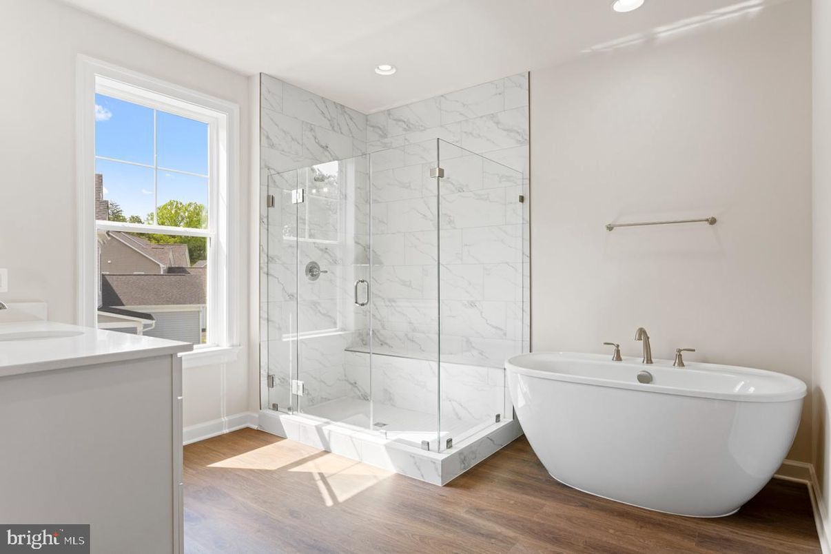 Bathroom, Free Standing Baths, Glass Shower, Interior, Marble Walls, Recessed Lighting, Wood Texture Flooring