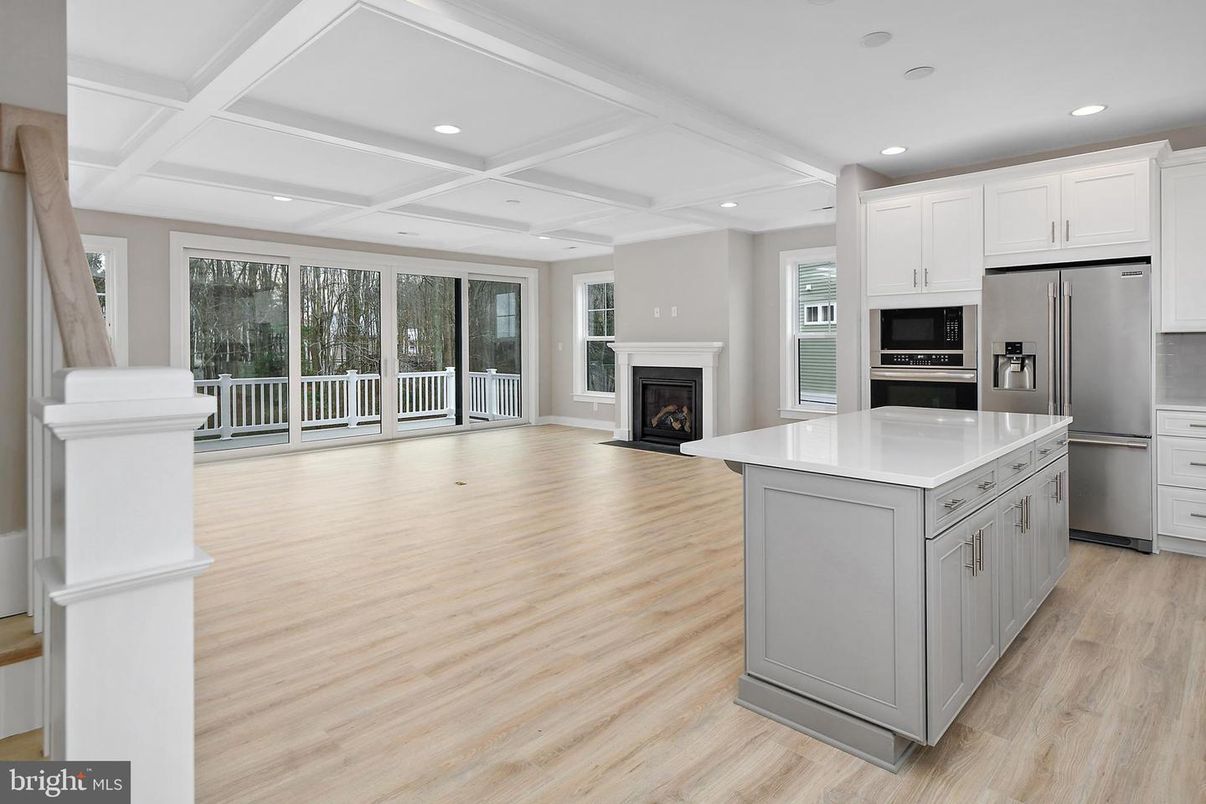 Fireplace, Interior, Kitchen, Recessed Lighting, Stainless Steel Appliances, Wood Texture Flooring