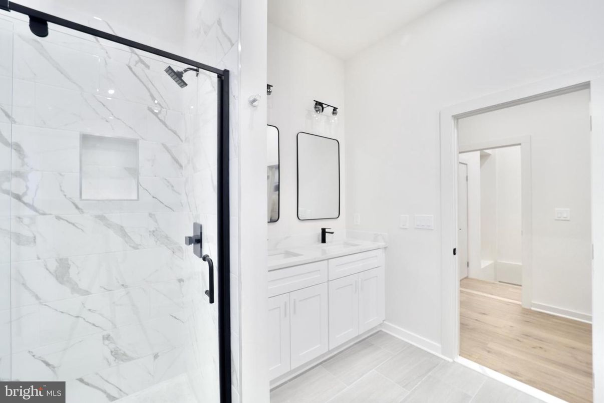 Bathroom, Dual Sink Vanities, Glass Shower, Interior, Marble Walls, Wood Texture Flooring