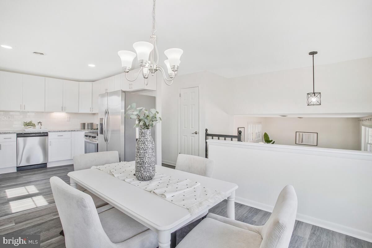 Chandelier, Dining room, Interior, Kitchen, Pendant Lights, Recessed Lighting, Stainless Steel Appliances, Wood Texture Flooring