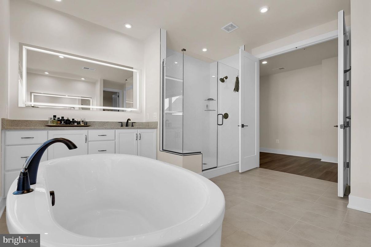 Bathroom, Dual Sink Vanities, Free Standing Baths, Glass Shower, Interior, Recessed Lighting, Wood Texture Flooring