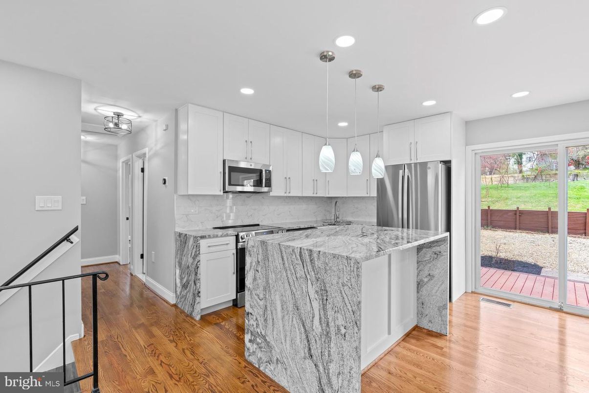 Interior, Kitchen, Marble Walls, Pendant Lights, Recessed Lighting, Stainless Steel Appliances, Wood Texture Flooring