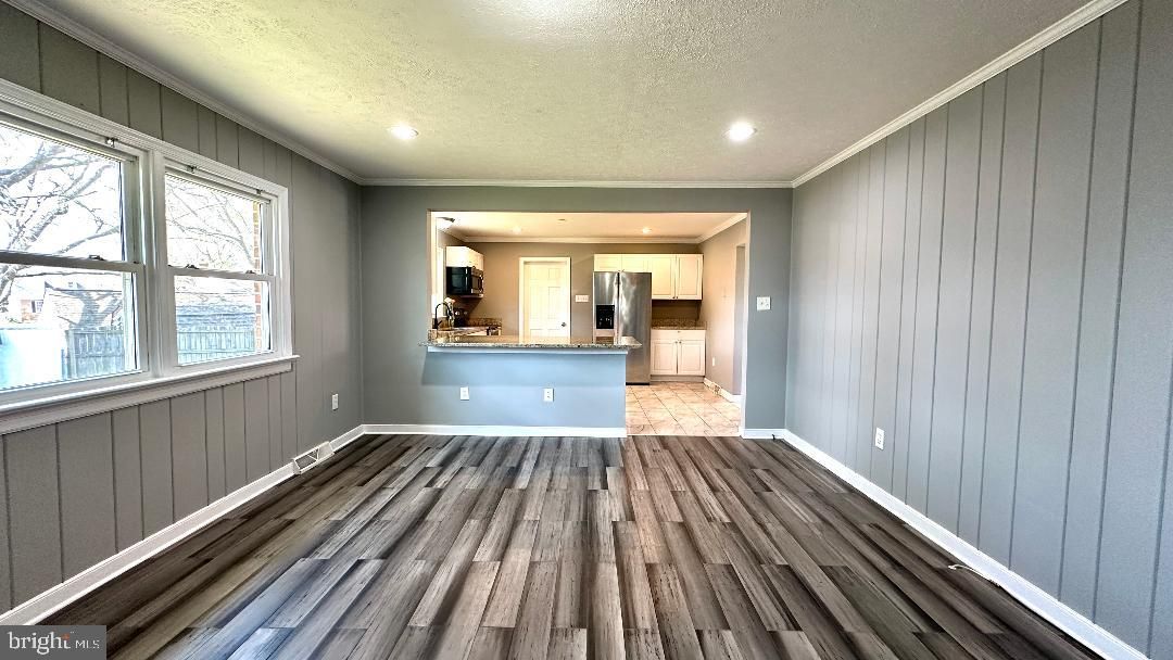 Empty room, Interior, Kitchen, Recessed Lighting, Stainless Steel Appliances, Wood Texture Flooring