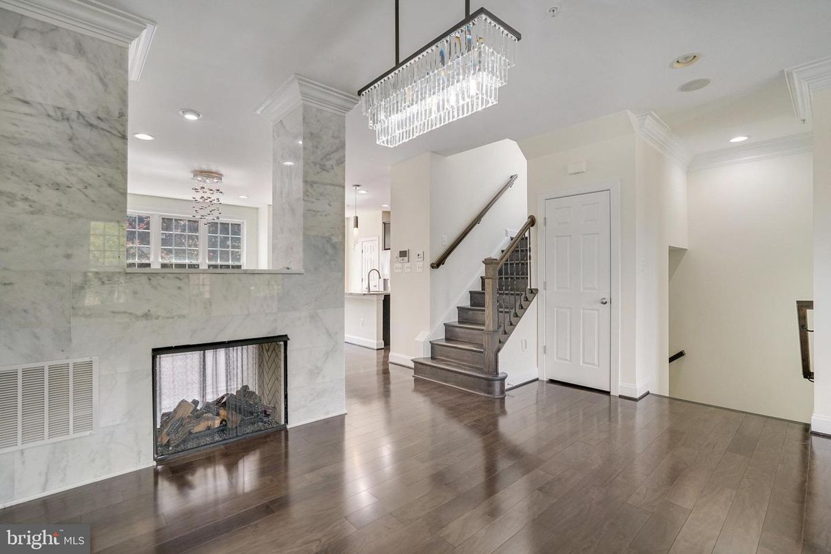 Chandelier, Fireplace, Interior, Marble Walls, Recessed Lighting, Wood Texture Flooring