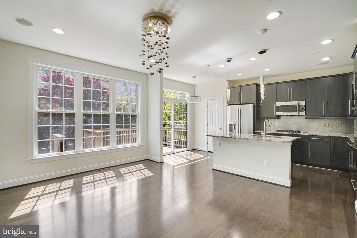 Empty room, Interior, Kitchen, Pendant Lights, Recessed Lighting, Stainless Steel Appliances, Wood Texture Flooring