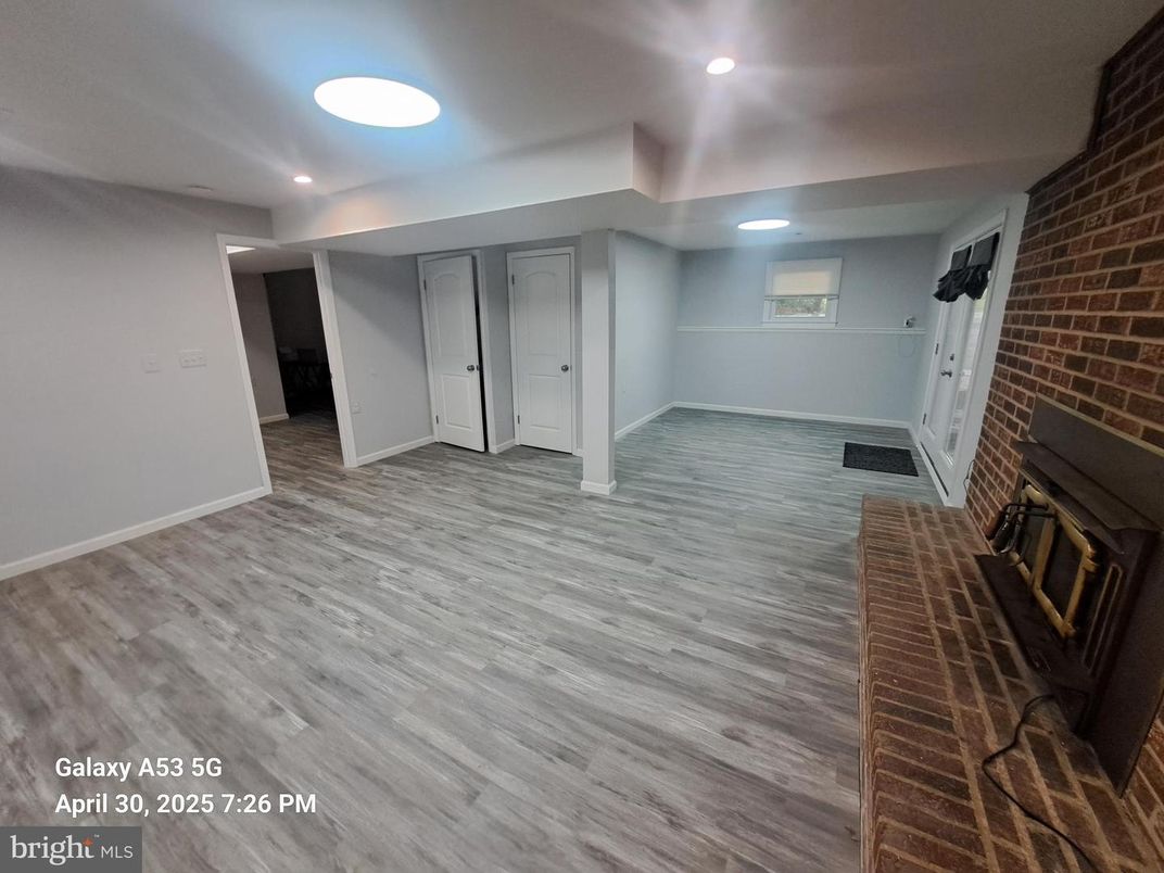 Empty room, Fireplace, Interior, Recessed Lighting, Stone Walls, Wood Texture Flooring