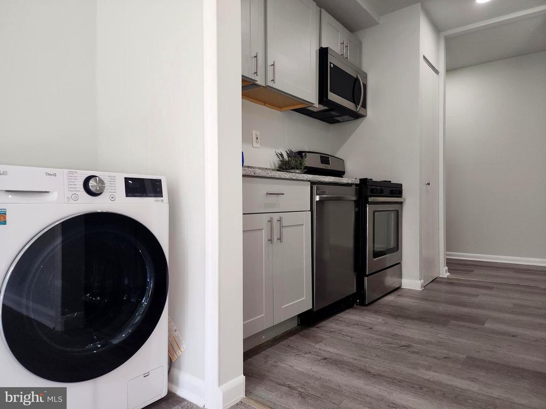 Interior, Kitchen, Recessed Lighting, Washer, Wood Texture Flooring