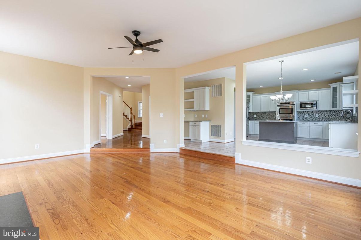 Chandelier, Empty room, Interior, Kitchen, Pendant Lights, Recessed Lighting, Stainless Steel Appliances, Wood Texture Flooring