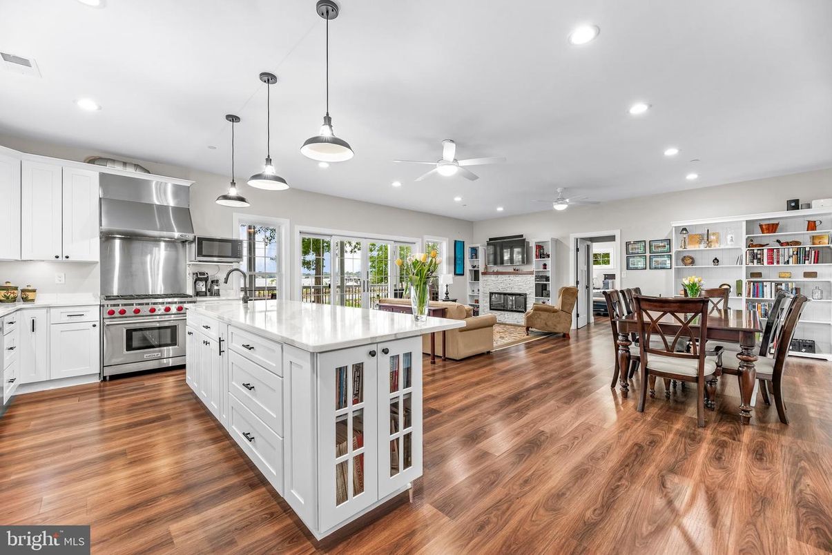 Dining room, Fireplace, Interior, Kitchen, Living room, Pendant Lights, Recessed Lighting, Stainless Steel Appliances, Wood Texture Flooring