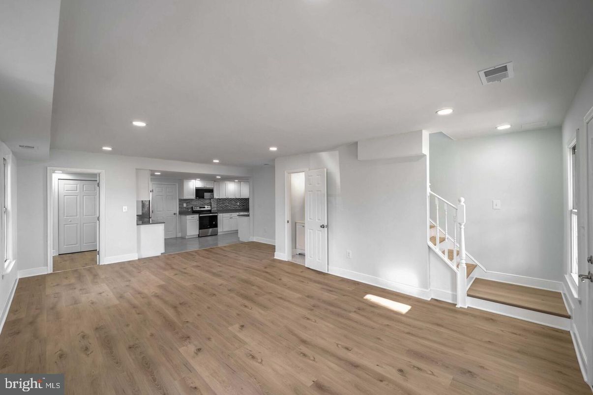 Empty room, Interior, Kitchen, Recessed Lighting, Stainless Steel Appliances, Wood Texture Flooring