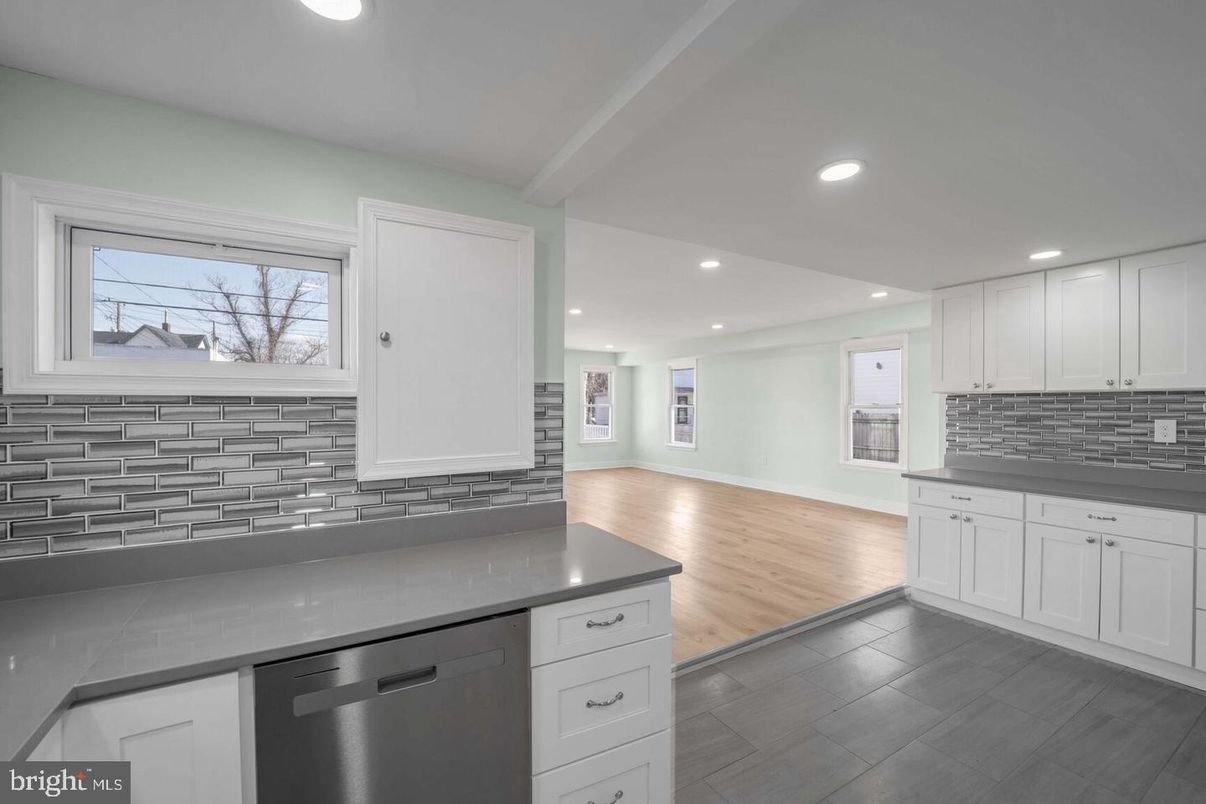 Empty room, Interior, Kitchen, Recessed Lighting, Stainless Steel Appliances, Wood Texture Flooring