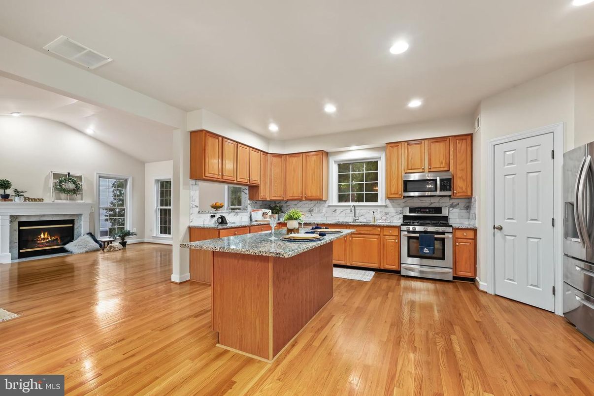 Fireplace, Interior, Kitchen, Recessed Lighting, Stainless Steel Appliances, Wood Texture Flooring