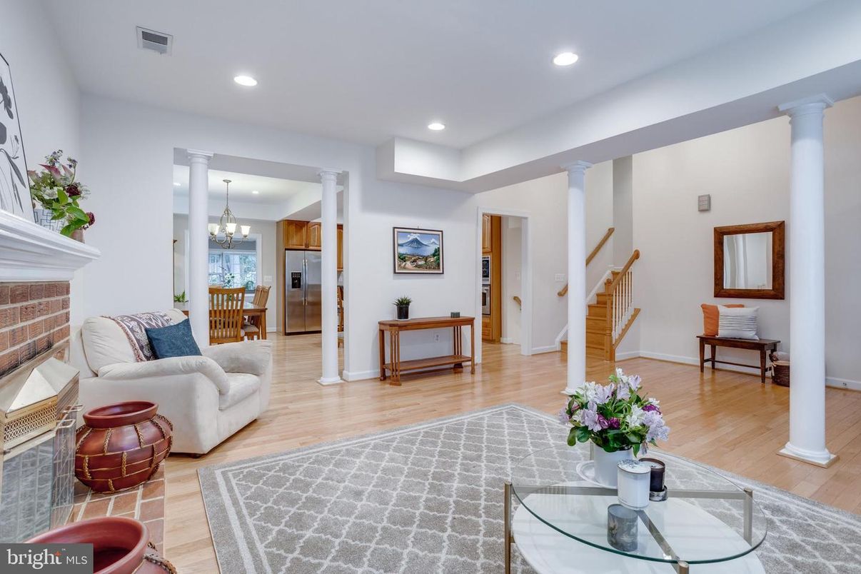 Chandelier, Fireplace, Interior, Living room, Recessed Lighting, Stainless Steel Appliances, Wood Texture Flooring