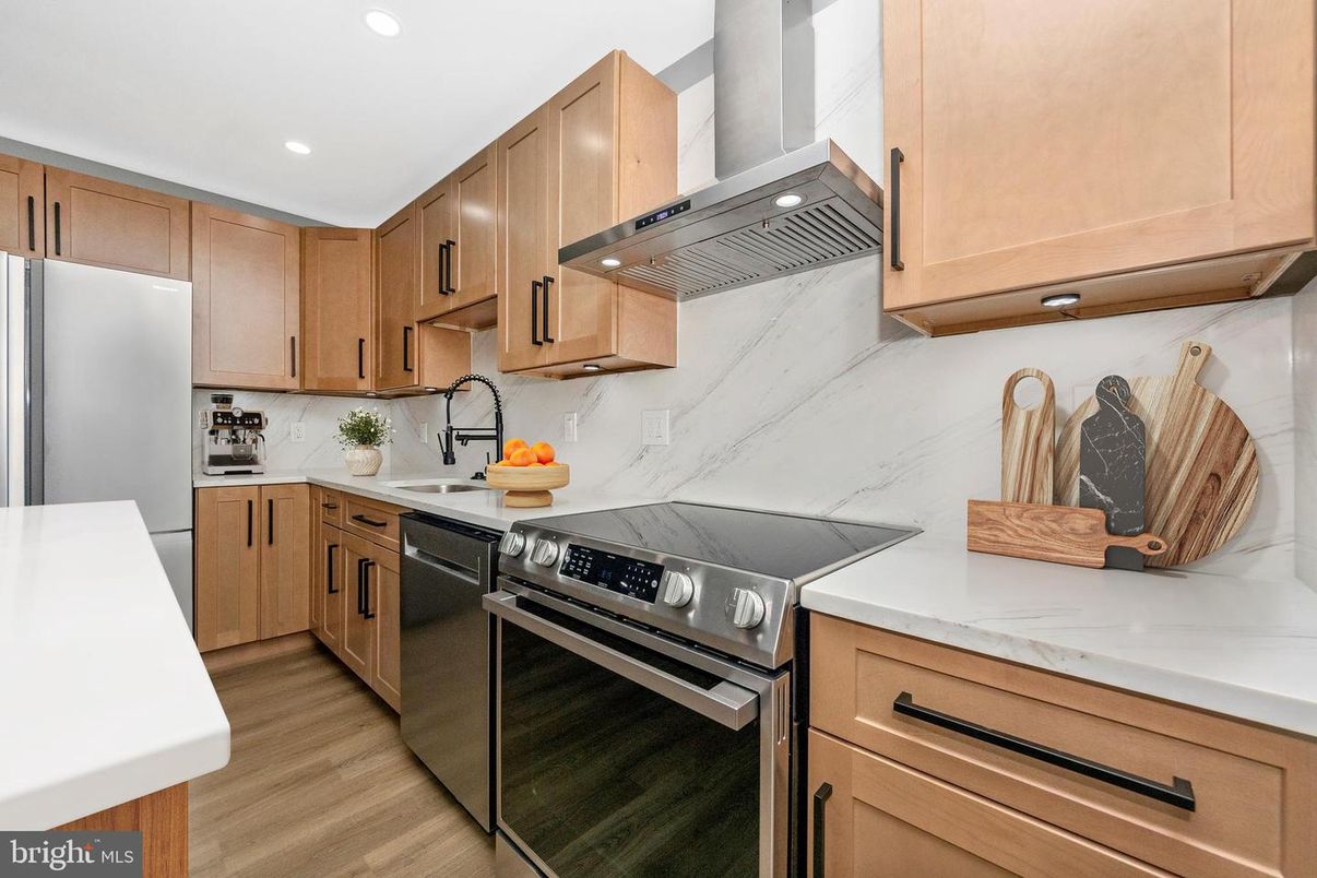 Interior, Kitchen, Marble Walls, Recessed Lighting, Stainless Steel Appliances, Wood Texture Flooring