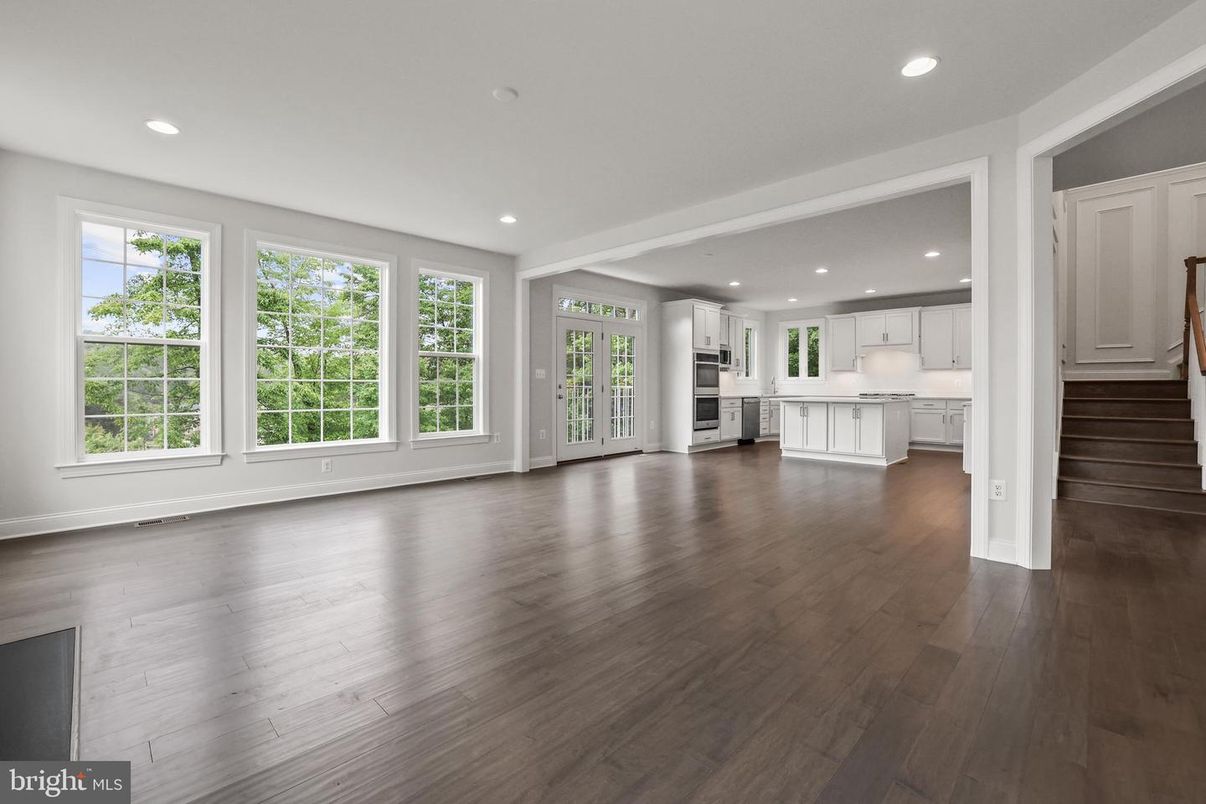 Empty room, Interior, Kitchen, Recessed Lighting, Stainless Steel Appliances, Wood Texture Flooring