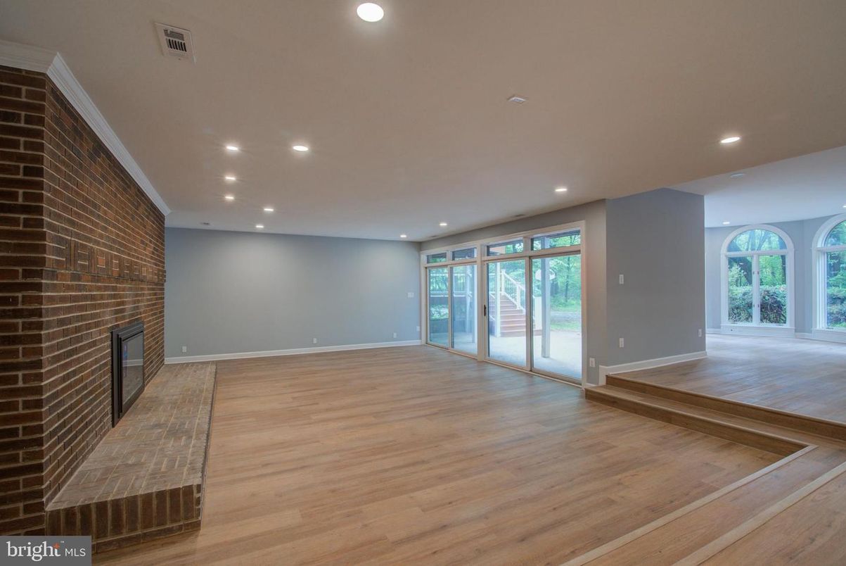 Empty room, Fireplace, Interior, Recessed Lighting, Stone Walls, Wood Texture Flooring