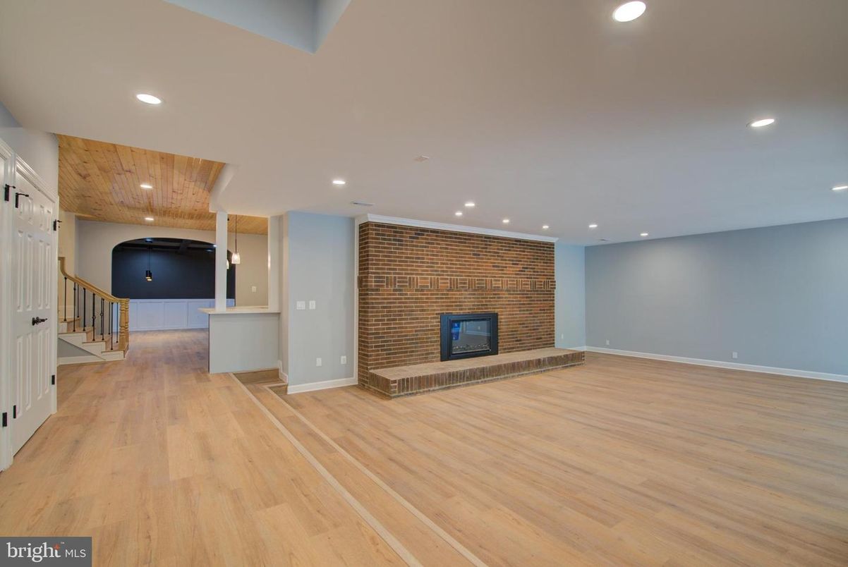 Empty room, Fireplace, Interior, Recessed Lighting, Stone Walls, Wood Texture Flooring