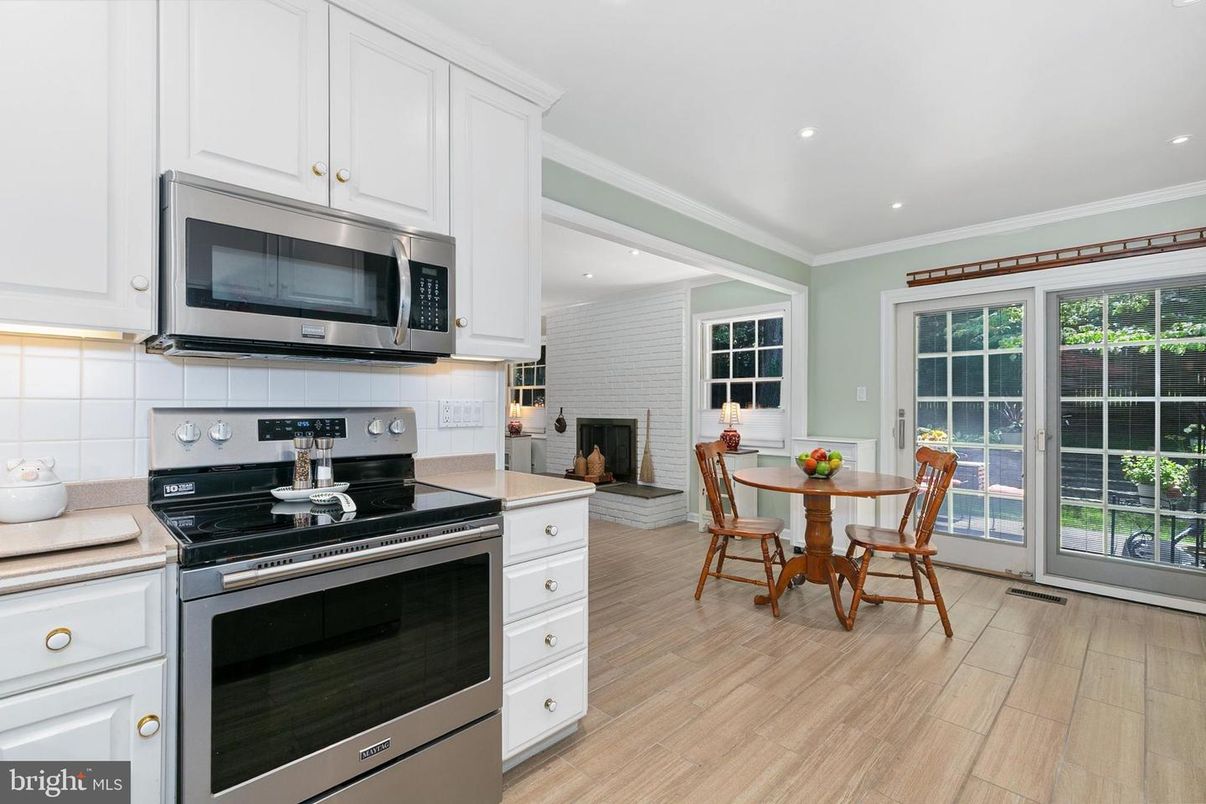 Dining room, Fireplace, Interior, Kitchen, Recessed Lighting, Stainless Steel Appliances, Stone Walls, Wood Texture Flooring