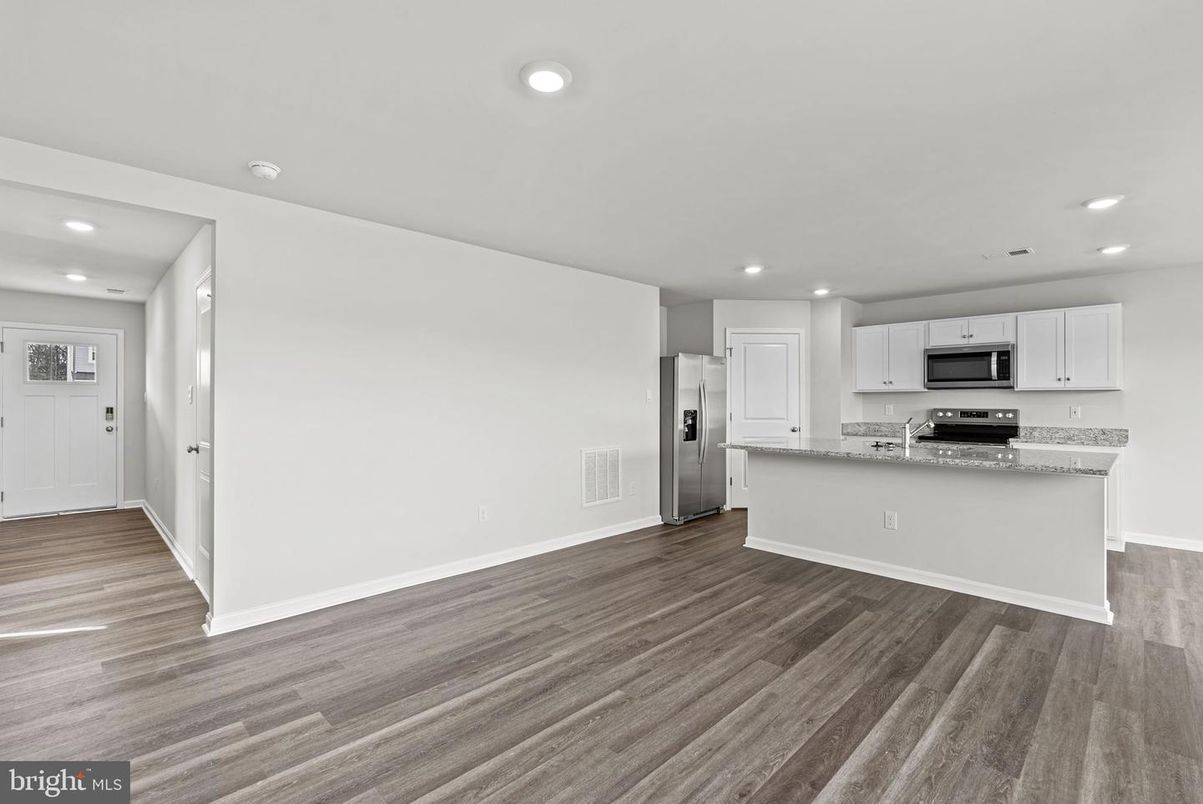 Empty room, Interior, Kitchen, Recessed Lighting, Stainless Steel Appliances, Wood Texture Flooring