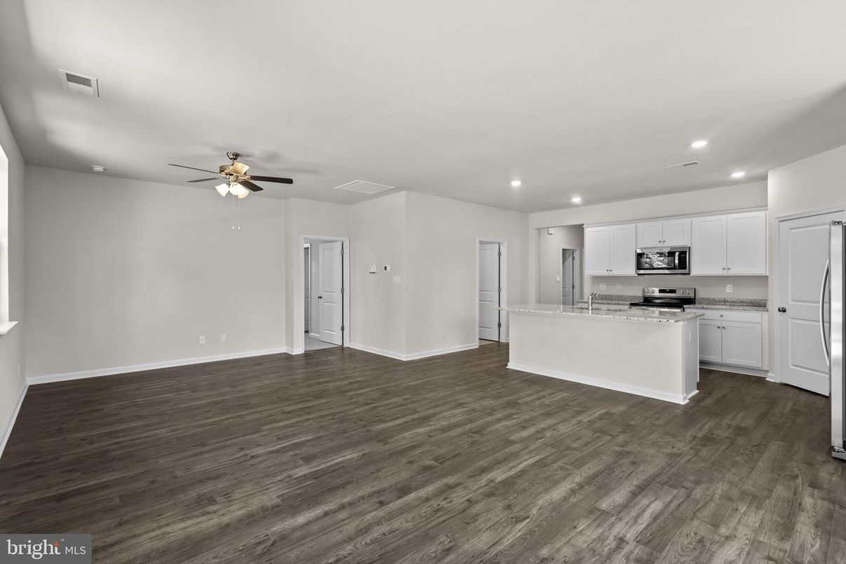 Empty room, Interior, Kitchen, Recessed Lighting, Stainless Steel Appliances, Wood Texture Flooring