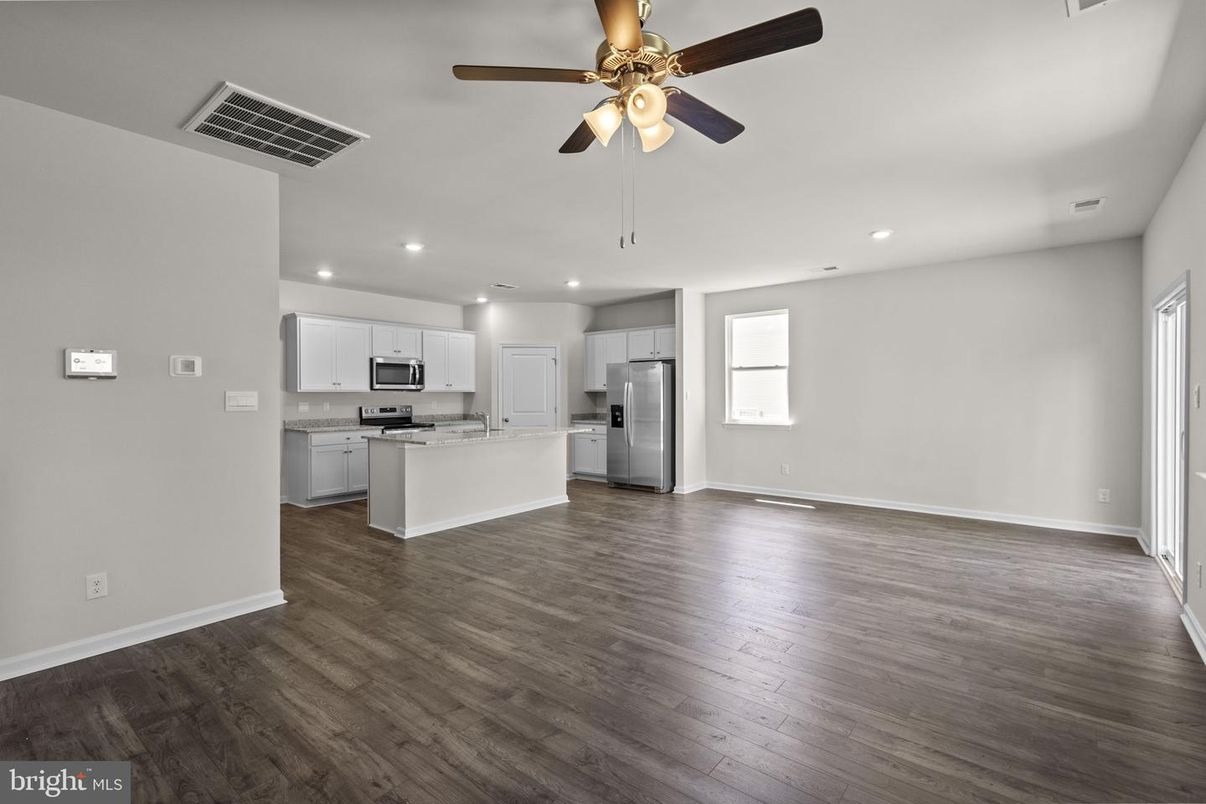 Empty room, Interior, Kitchen, Recessed Lighting, Stainless Steel Appliances, Wood Texture Flooring