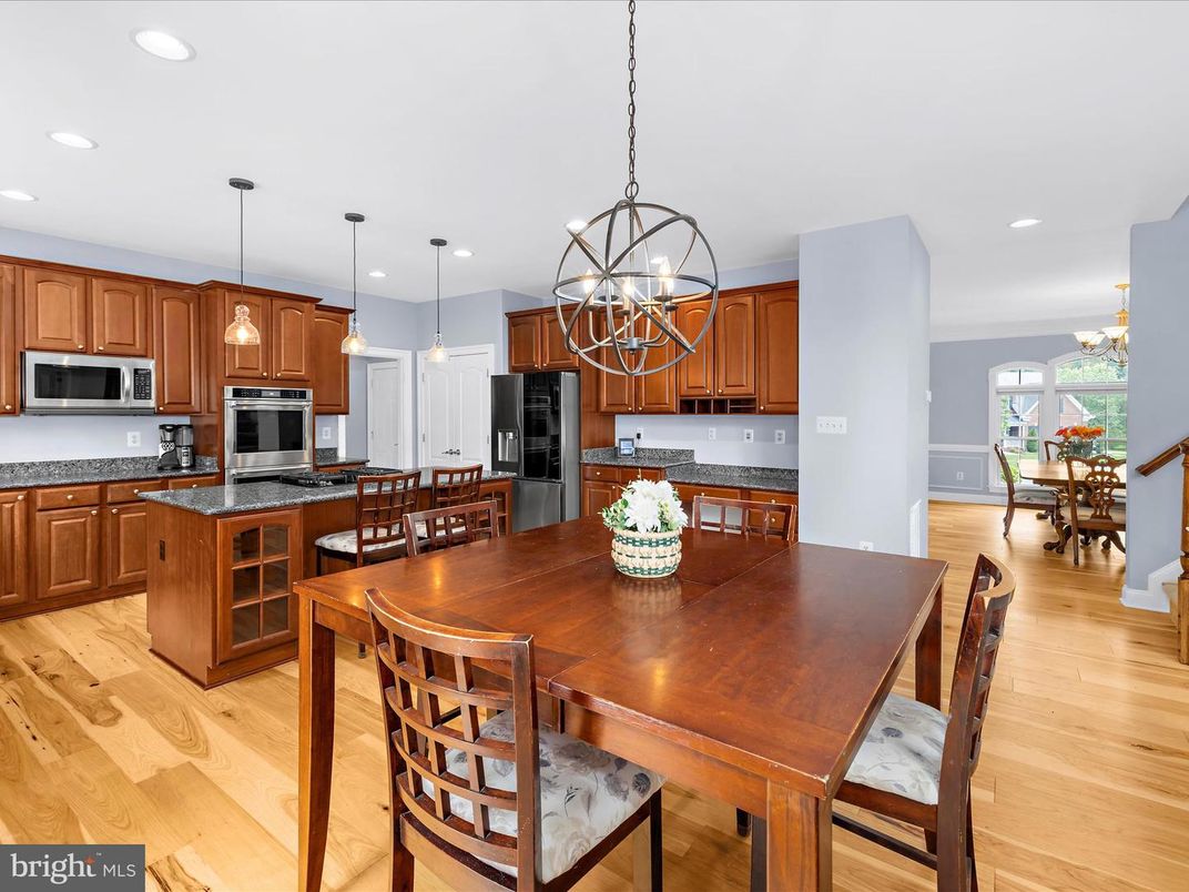 Chandelier, Dining room, Interior, Kitchen, Pendant Lights, Recessed Lighting, Stainless Steel Appliances, Wood Texture Flooring