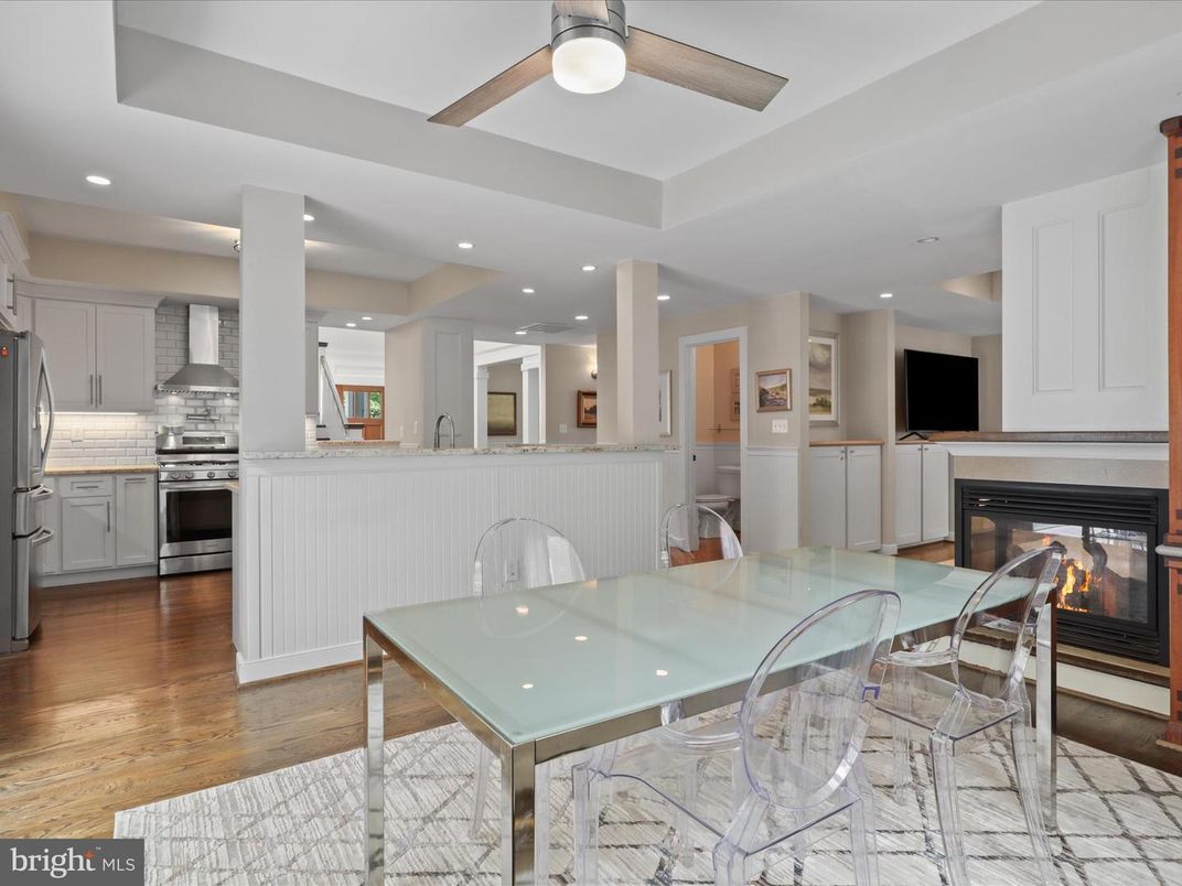 Dining room, Fireplace, Interior, Kitchen, Recessed Lighting, Stainless Steel Appliances, Wood Texture Flooring
