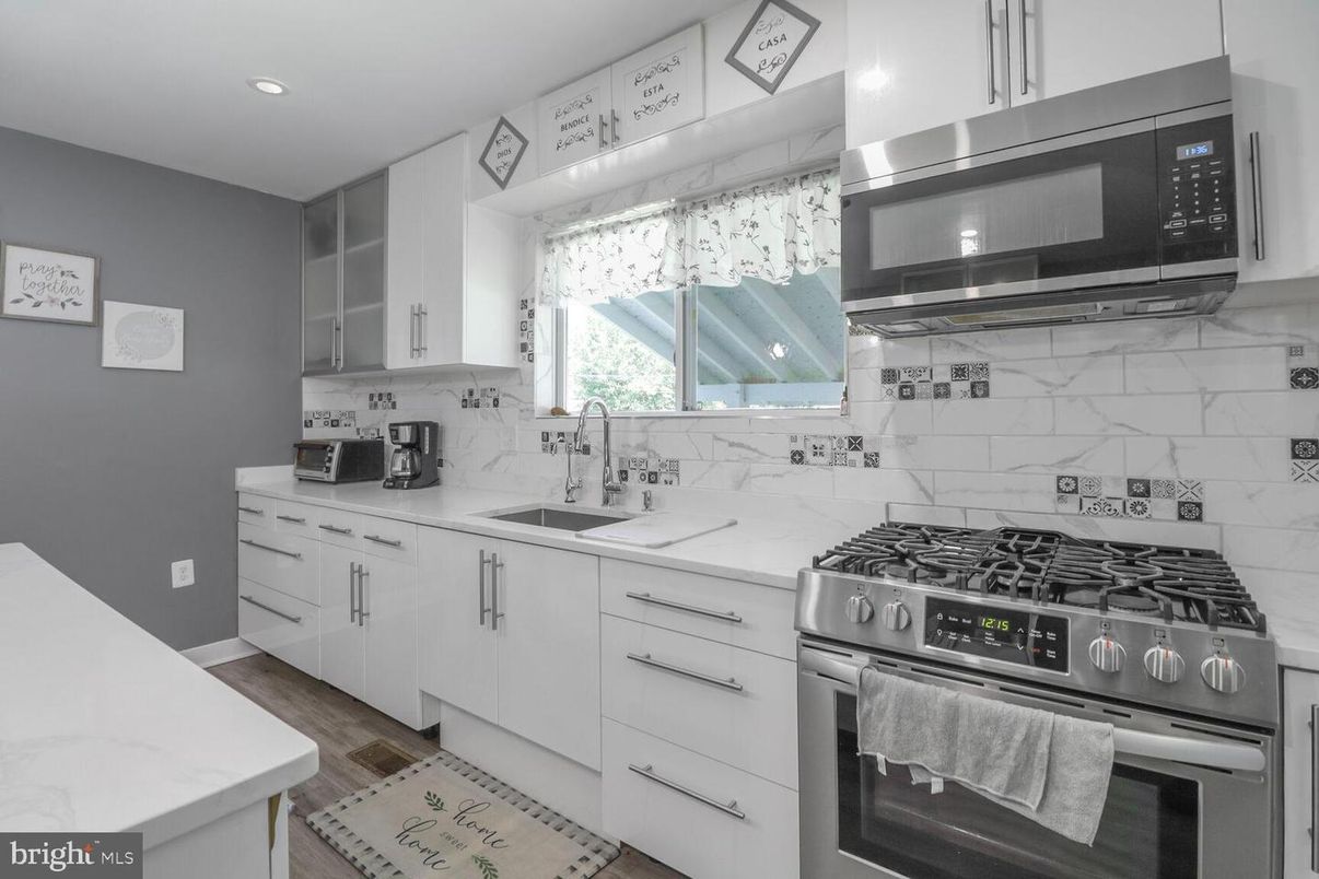 Interior, Kitchen, Marble Walls, Recessed Lighting, Stainless Steel Appliances, Wood Texture Flooring