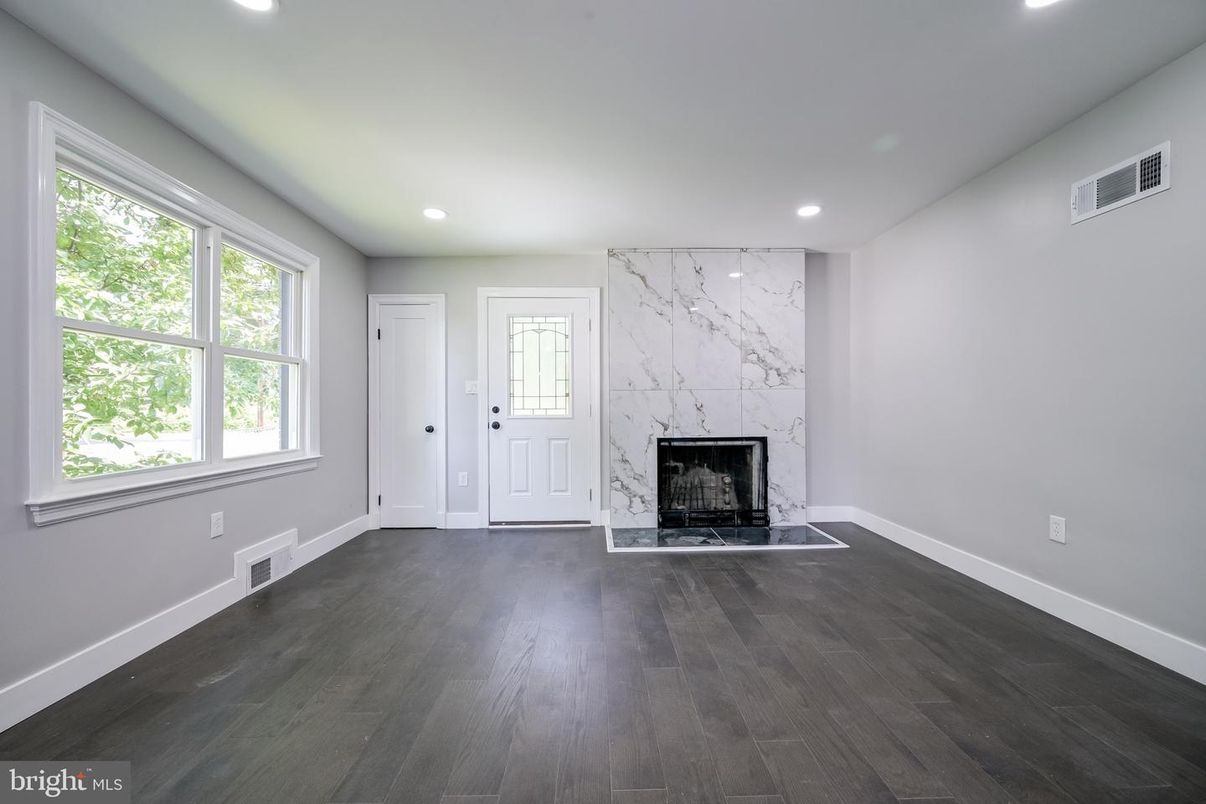 Empty room, Fireplace, Interior, Marble Walls, Recessed Lighting, Wood Texture Flooring