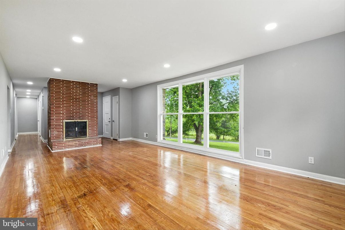 Empty room, Fireplace, Interior, Recessed Lighting, Stone Walls, Wood Texture Flooring