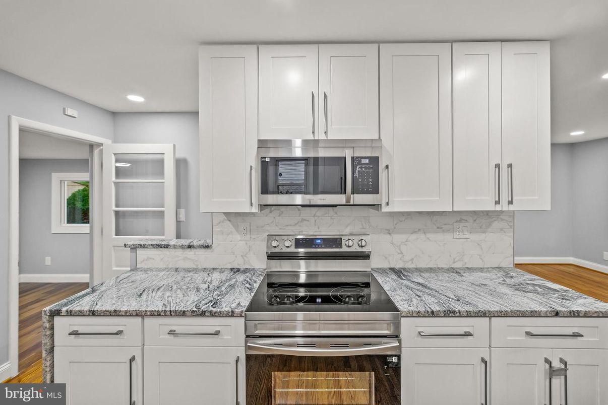 Interior, Kitchen, Marble Walls, Recessed Lighting, Stainless Steel Appliances, Wood Texture Flooring
