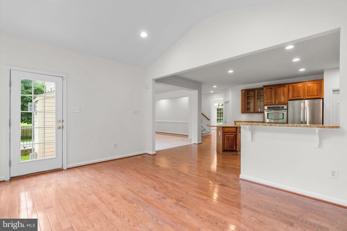 Empty room, Interior, Kitchen, Recessed Lighting, Stainless Steel Appliances, Wood Texture Flooring