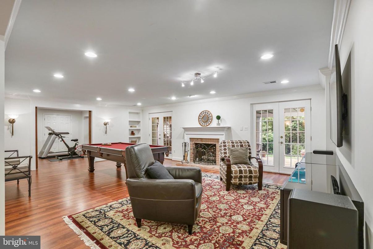 Billiard Table, Fireplace, Fitness Equipment, Game Room, Interior, Living room, Recessed Lighting, Wood Texture Flooring