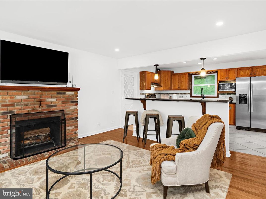 Fireplace, Interior, Kitchen, Pendant Lights, Recessed Lighting, Stainless Steel Appliances, Stone Walls, Wood Texture Flooring