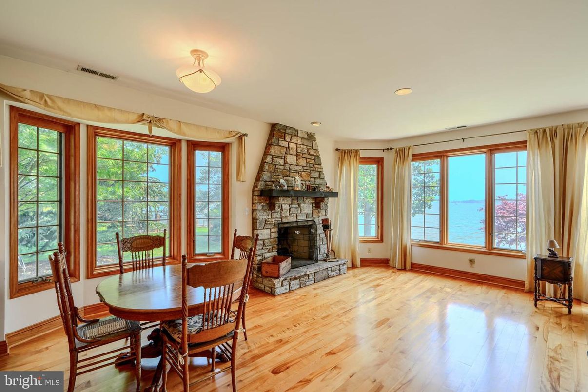 Dining room, Fireplace, Interior, Recessed Lighting, Stone Walls, Wood Texture Flooring