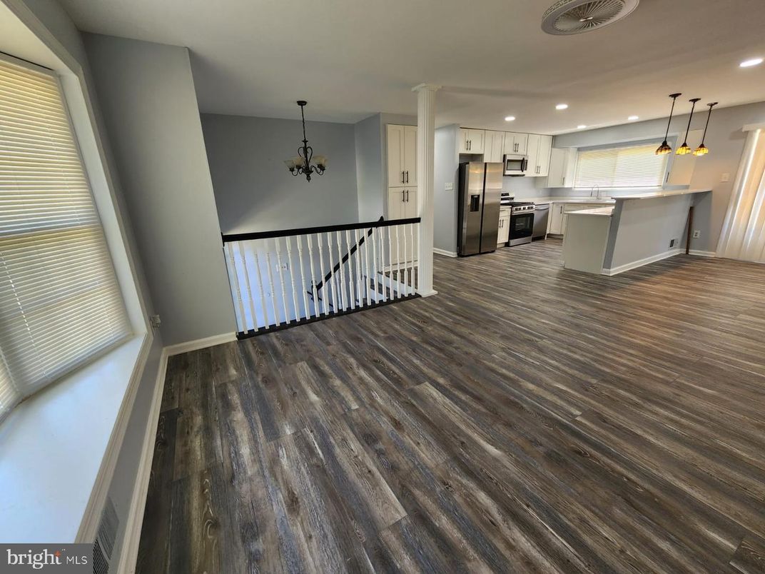 Chandelier, Empty room, Interior, Kitchen, Pendant Lights, Recessed Lighting, Stainless Steel Appliances, Wood Texture Flooring