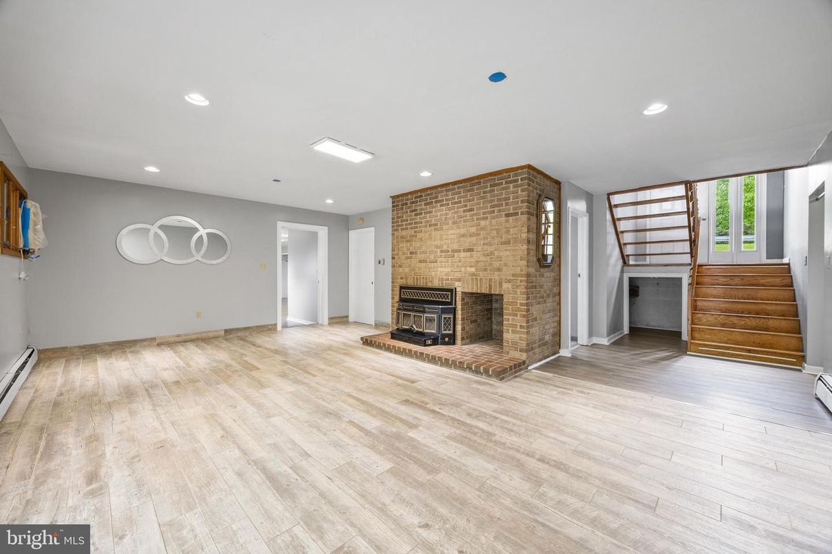 Empty room, Fireplace, Interior, Recessed Lighting, Stone Walls, Wood Texture Flooring