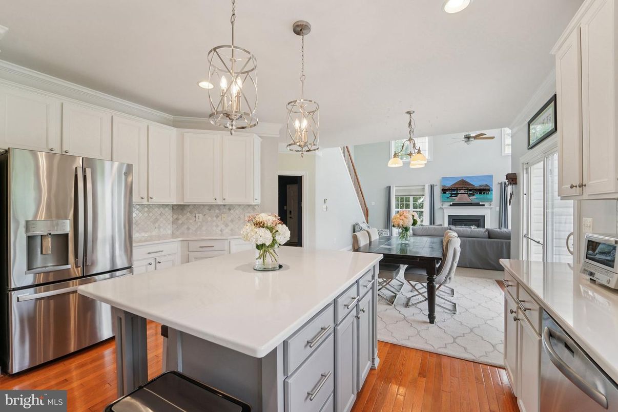 Dining room, Fireplace, Interior, Kitchen, Pendant Lights, Recessed Lighting, Stainless Steel Appliances, Wood Texture Flooring