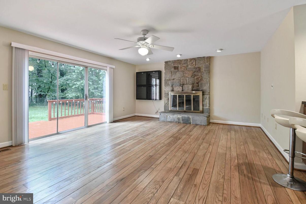 Empty room, Fireplace, Interior, Recessed Lighting, Stone Walls, Wood Texture Flooring