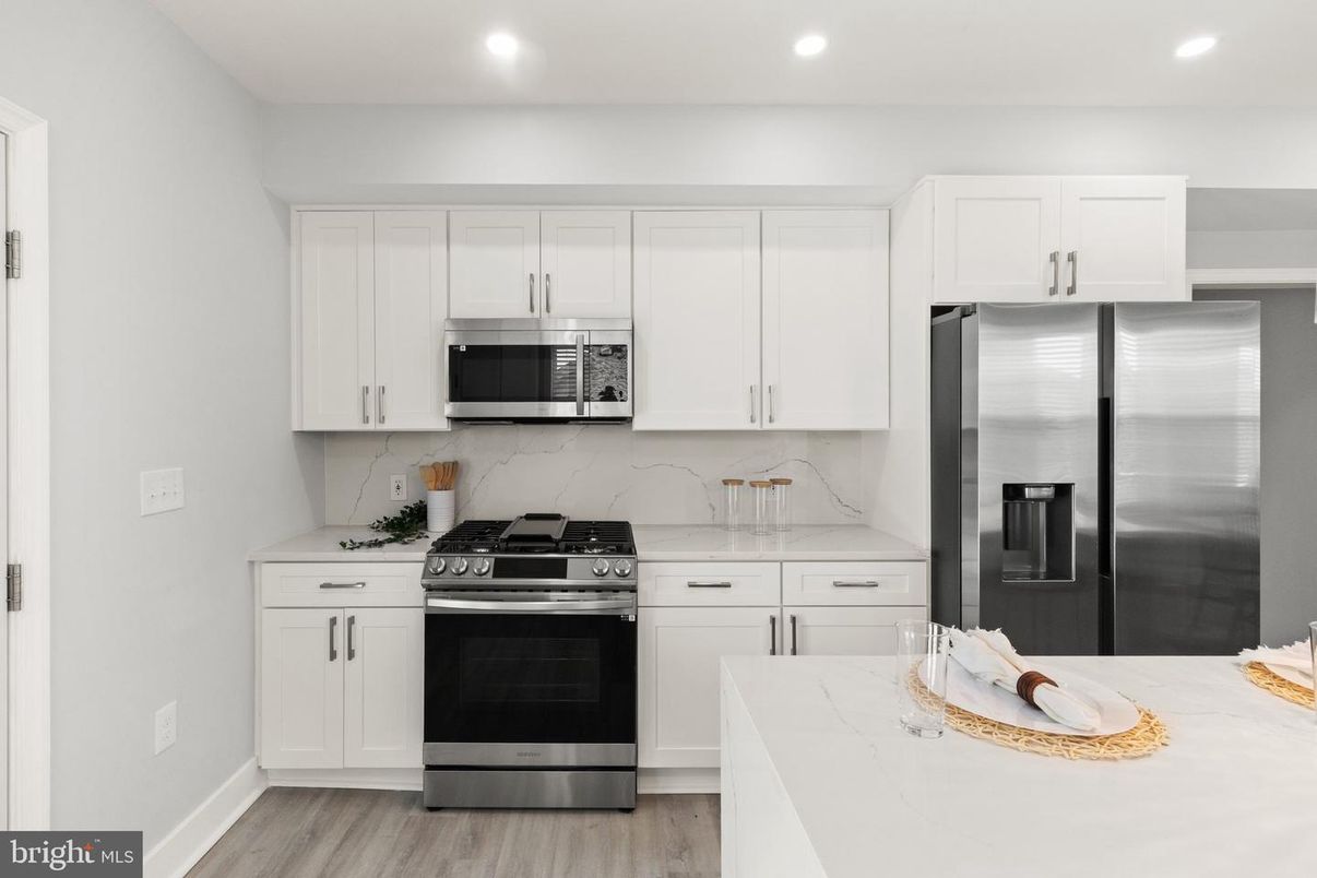 Interior, Kitchen, Marble Walls, Recessed Lighting, Stainless Steel Appliances, Wood Texture Flooring