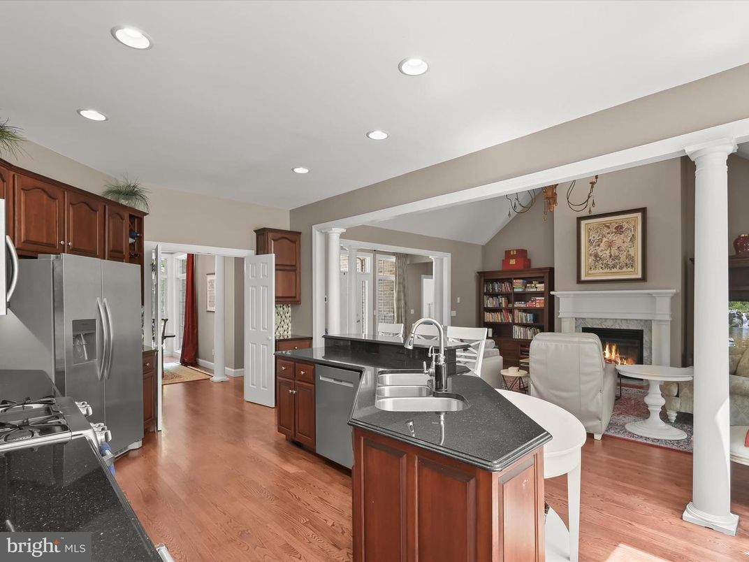 Dining room, Fireplace, Interior, Kitchen, Living room, Recessed Lighting, Stainless Steel Appliances, Wood Texture Flooring