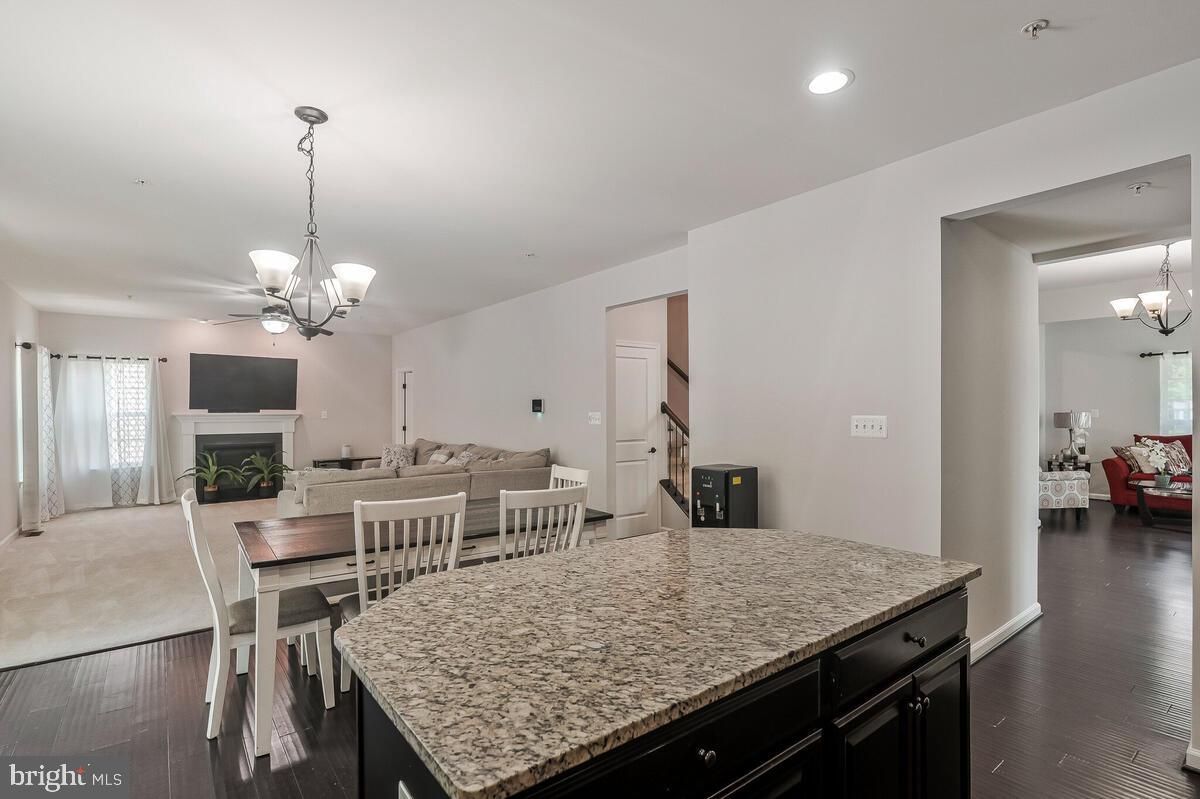 Chandelier, Dining room, Fireplace, Interior, Living room, Pendant Lights, Recessed Lighting, Wood Texture Flooring