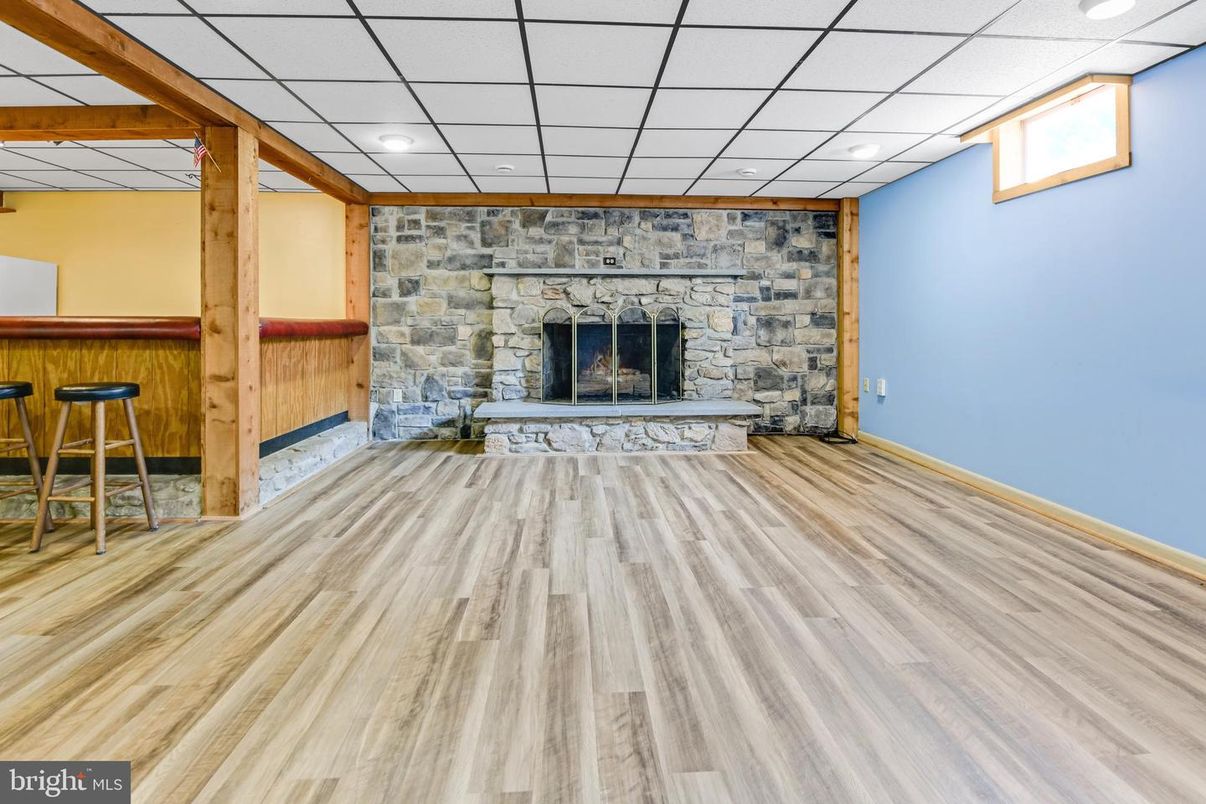 Empty room, Fireplace, Interior, Recessed Lighting, Stone Walls, Wood Texture Flooring