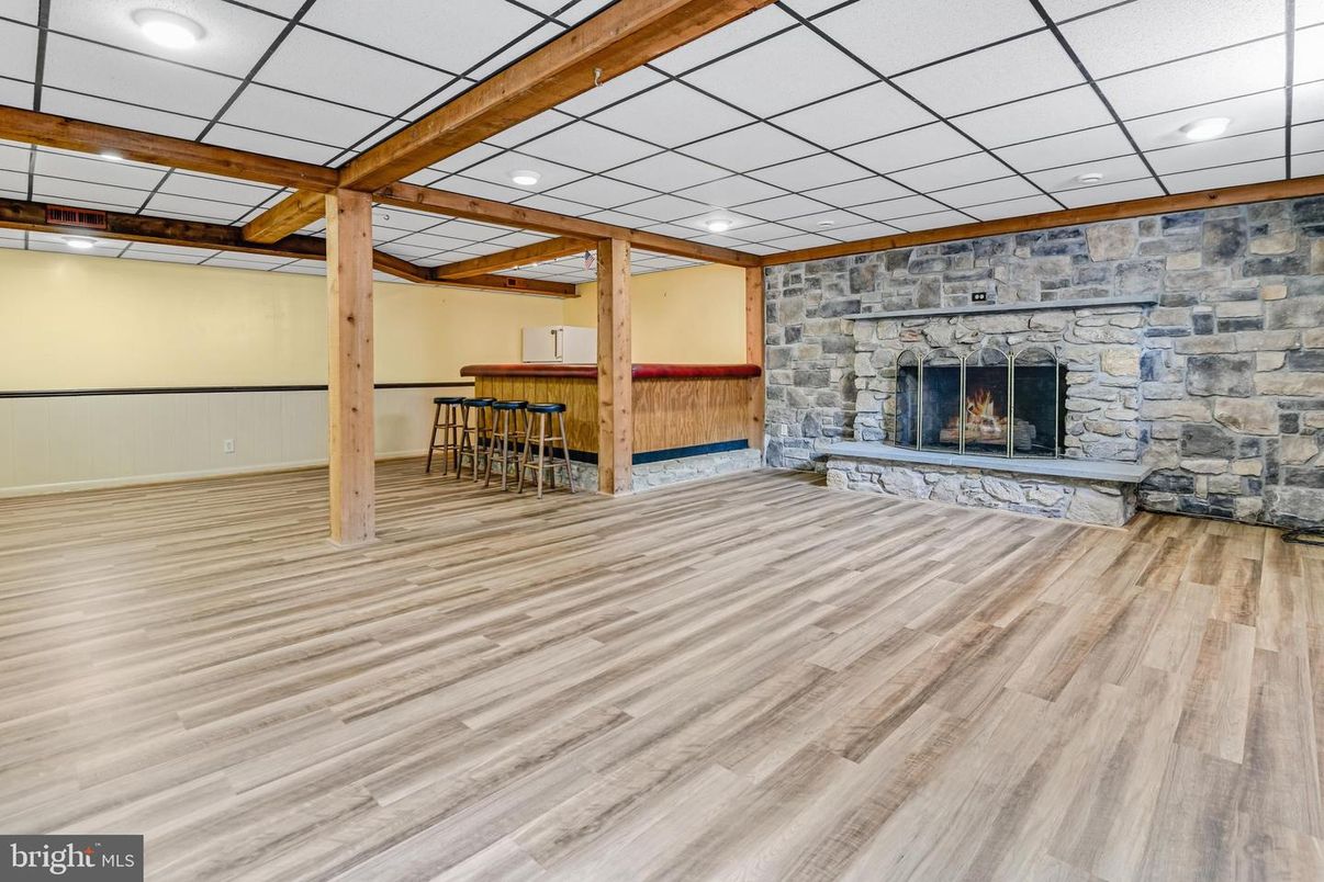 Empty room, Fireplace, Interior, Recessed Lighting, Stone Walls, Wooden Beams, Wood Texture Flooring