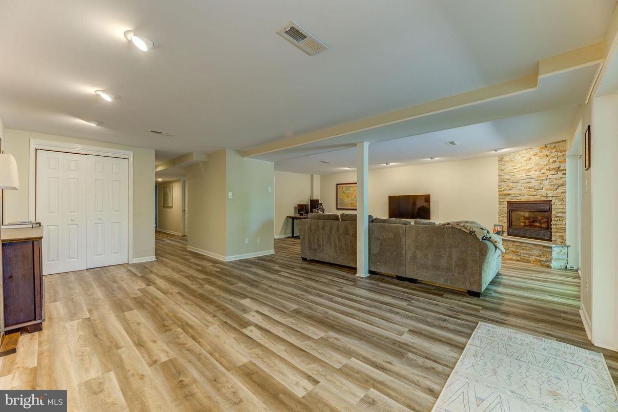 Fireplace, Interior, Living room, Recessed Lighting, Stone Walls, Wood Texture Flooring
