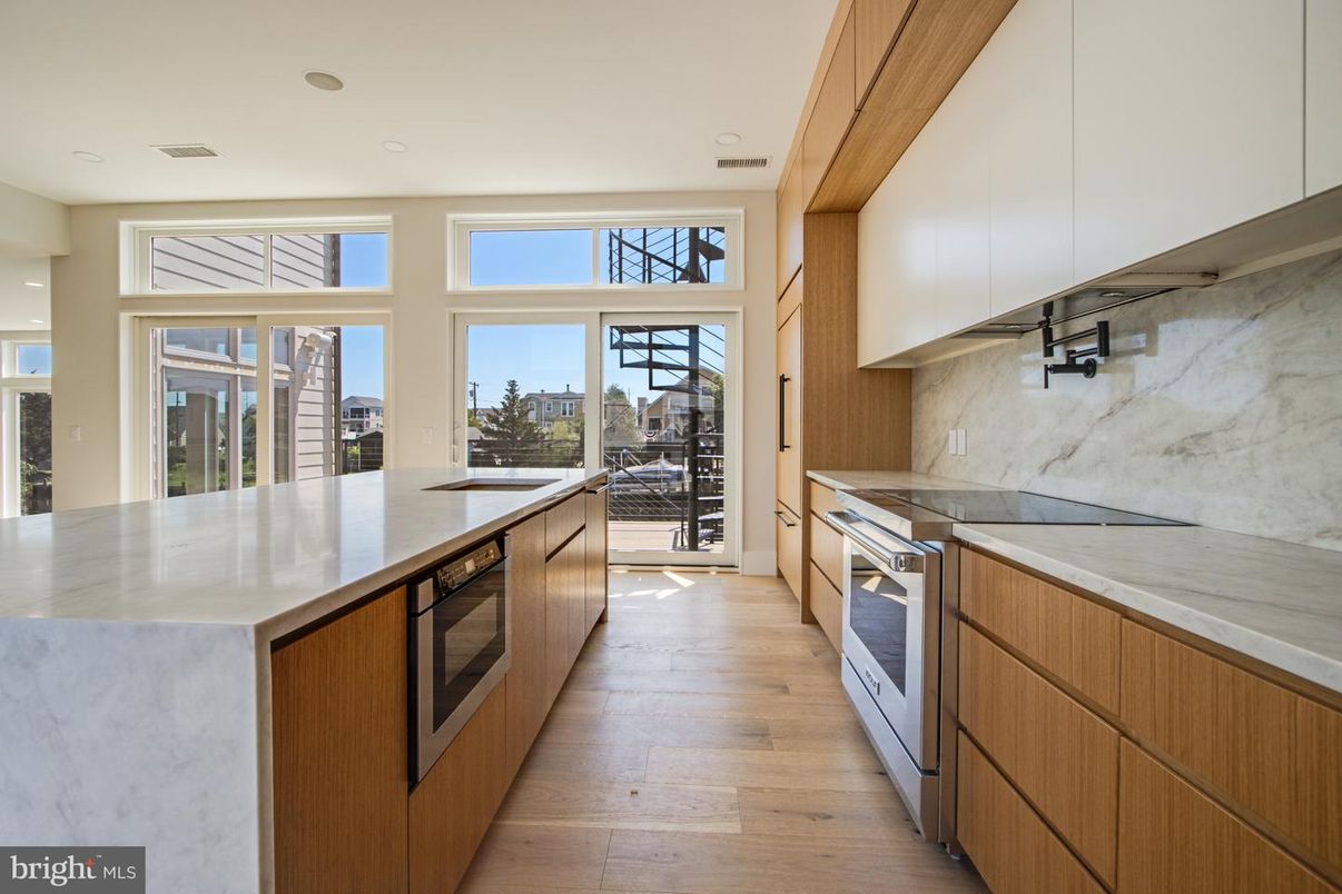 Interior, Kitchen, Marble Walls, Recessed Lighting, Stainless Steel Appliances, Wood Texture Flooring