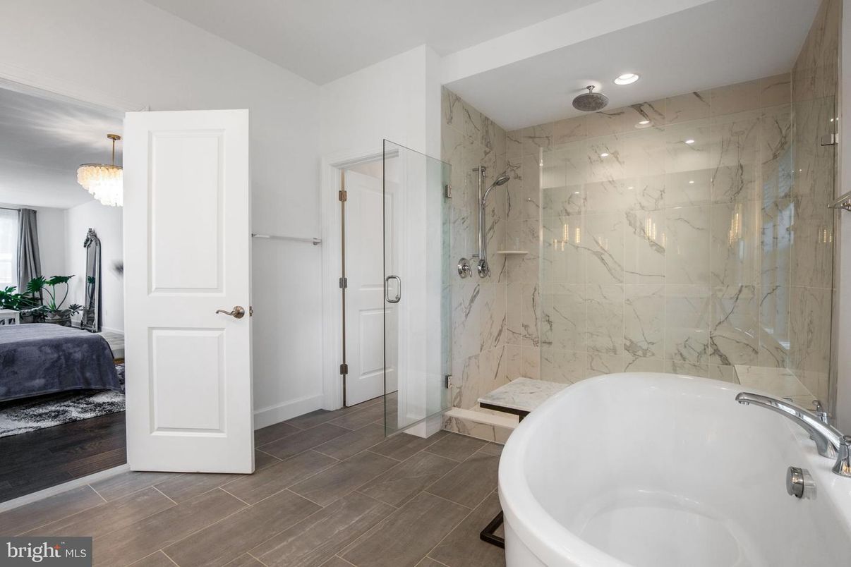 Bathroom, Chandelier, Free Standing Baths, Glass Shower, Interior, Marble Walls, Recessed Lighting, Wood Texture Flooring